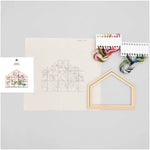 Embroidery kit contents including pre-printed cotton fabric, threads, and wooden frame