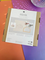 Back of Orchids embroidery kit box listing 100% cotton fabric and frame details