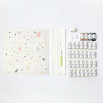 Latch hook rug kit with terrazzo cushion design by Rico Design