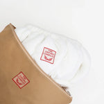 Oxford Punch Needle Frame Cover in white fleece with red embroidered label inside storage bag
