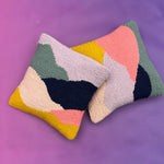 Set of two textured looped punch needle pillows in mustard, navy, and coral pink