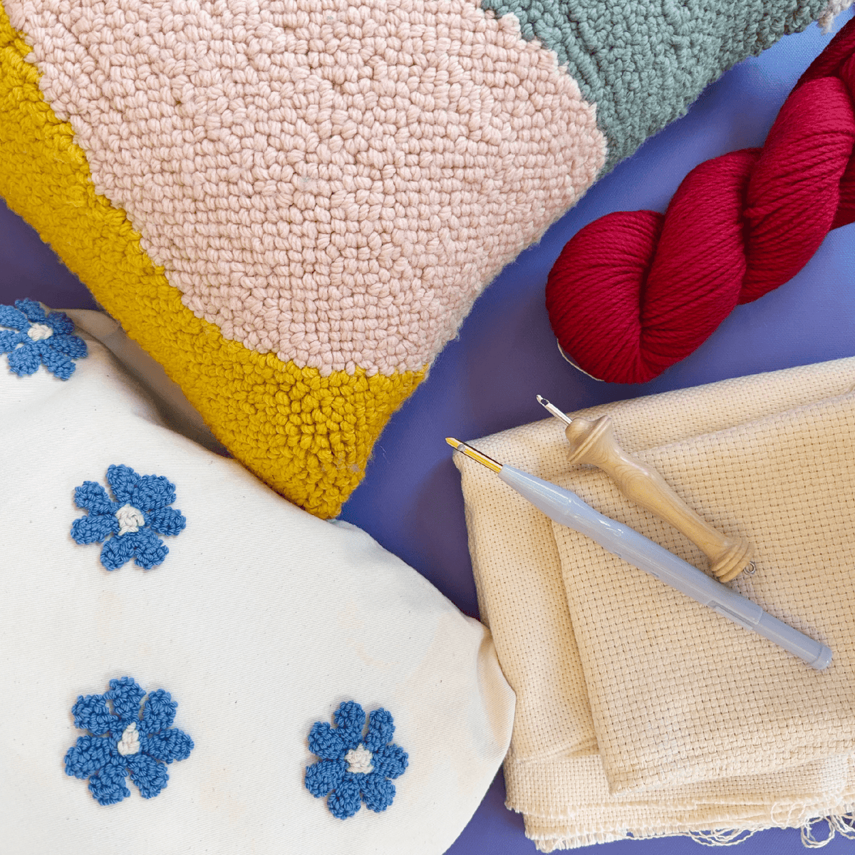 Tufted pillow and punch needle materials flat lay