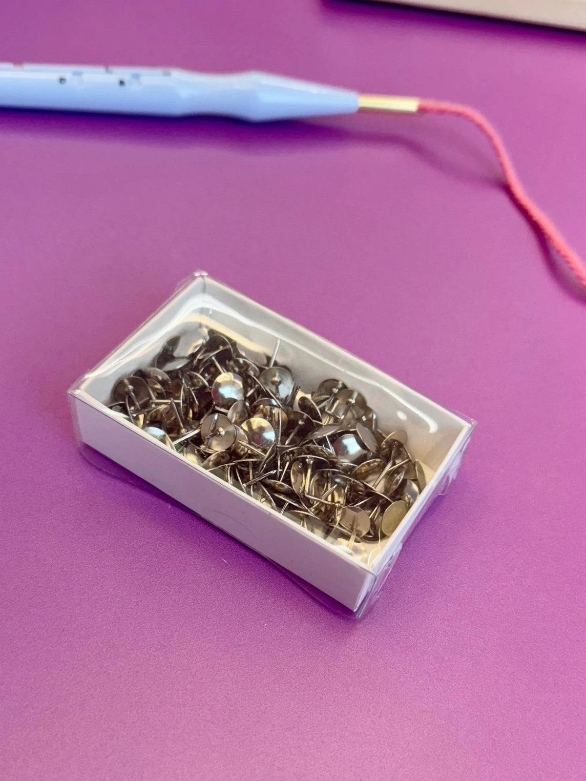 Rico thumbtacks for punch needle frames, in use